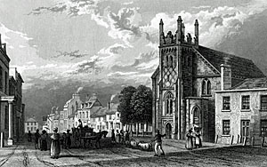 Etching of wide street with shops and house. The church is in the center. Depicts a peaceful rural town.